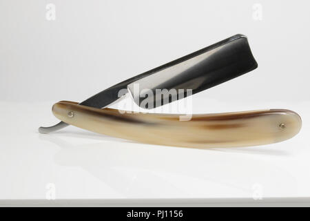 Straight Razor, Cut throat Shaving Razor used by Barbers. Classic Vintage shaving tool used for men's grooming. Close up of a shaving razor blade with Stock Photo