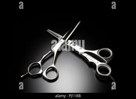 Hair stylist high end salon grooming tools. Chrome and Black contrast. Hair dressing equipment. Texturizing shears, scissors, thinning scissors. Stock Photo