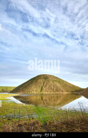 Silbury Hill with water in Wiltshire Stock Photo