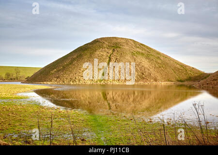 Silbury Hill with water in Wiltshire Stock Photo