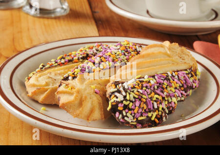 A plate of gourmet shortbread cookies dipped in chocolate, with candy sprinkles Stock Photo