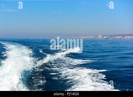 Wavy trail on the Mediterranean Sea after vessel, ship, ferry speed floating. Tourist ferry in the swim in Mediterranean Sea  from Santa Pola Spain Stock Photo