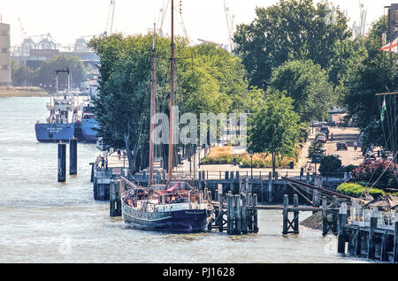 Rotterdam, The Netherlands, August 3, 2018: view from Erasmusbridge towards Westerkade quay with trees, flower beds and moored yachts and larger vesse Stock Photo