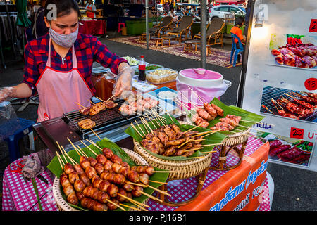 Steet Food Vendor Grilling meat for night market in Chiang Mai. Stock Photo