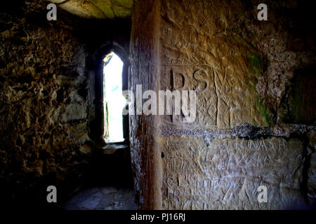 Ancient graffiti on a medieval stone wall Stock Photo