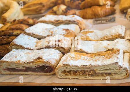 Puff cakes with cherries and apples on the market. Stock Photo
