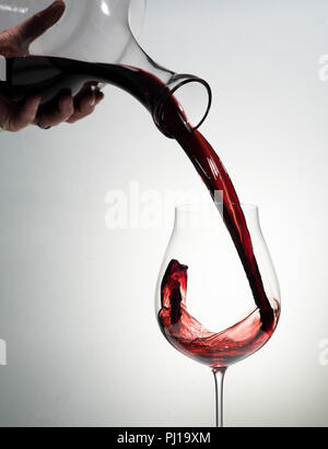 Red wine being poured in a glass. Stock Photo