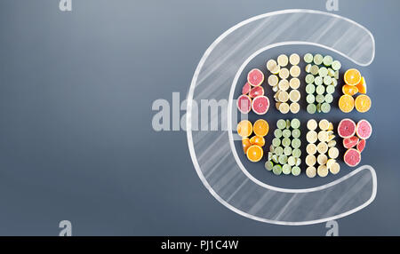 Many citrus fruits in the shape of a sliced fruit icon inside the letter c on a chalkboard background Stock Photo
