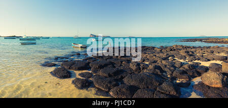 Boats in a sea at day time. Flat island on a background. Mauritius. beautiful landscape panorama. Stock Photo