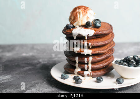 Chocolate Pancakes with Blueberry and Ice Cream on grey background, Homemade Dessert, Tasty Sweet Breakfast Stock Photo