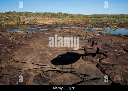 Australia, Western Australia, Kimberley, Hunter River Region. Mitchell River Plateau, Shadow of sightseeing helicopter on remote landing site. Stock Photo