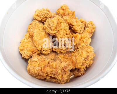 above view of roasted spicy chicken wings in bucket cut out on white Stock Photo