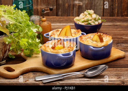 Italian dessert with baked pears in bowl with ricotta and almonds. Stock Photo
