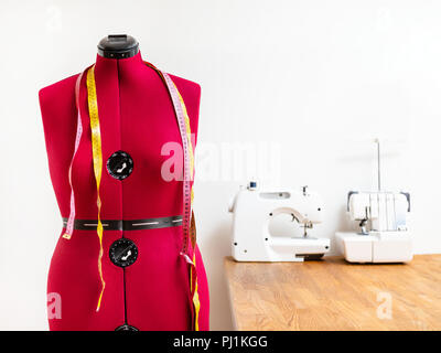 front view tailor's dummy with two measuring tapes in dressmaker workshop Stock Photo