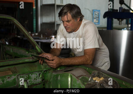 Male mechanic using digital tablet Stock Photo
