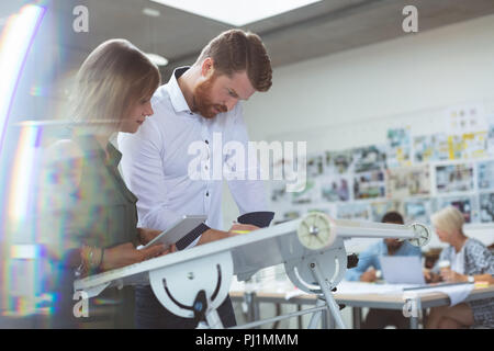 Executives working on drafting table Stock Photo
