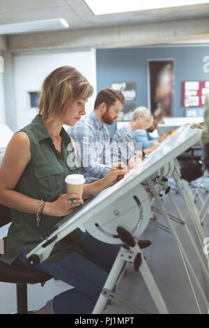 Executives working on drafting table Stock Photo