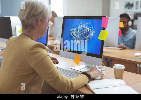 Businesswoman working on desktop pc at desk Stock Photo