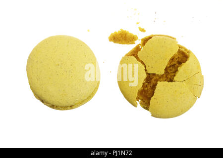 broken yellow macarons isolated on white background closeup. Stock Photo