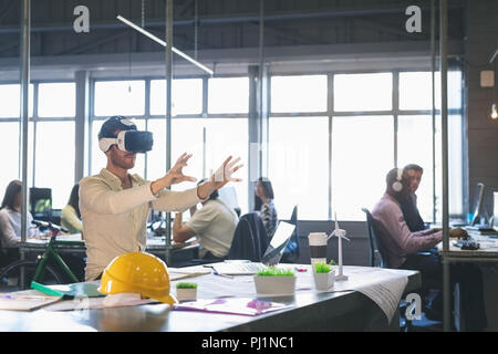 Male executive using virtual reality headset Stock Photo