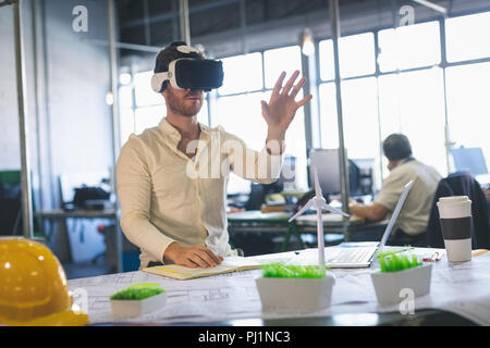 Male executive using virtual reality headset Stock Photo