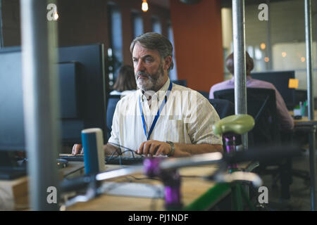 Male executive working on computer at desk Stock Photo