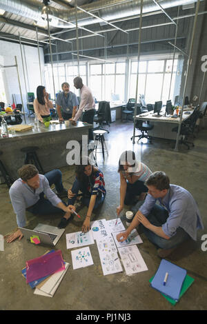 Business people discussing over documents Stock Photo
