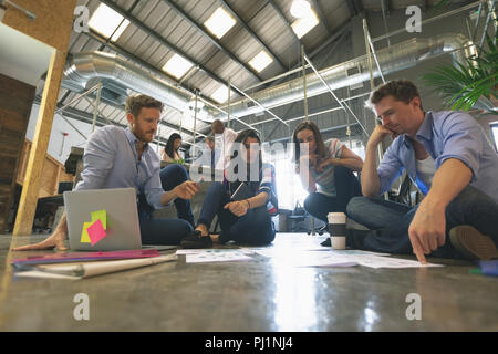 Business people discussing over documents Stock Photo