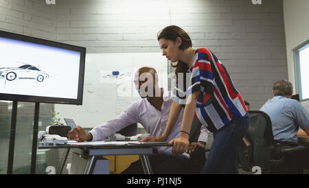 Business colleagues discussing over a project Stock Photo