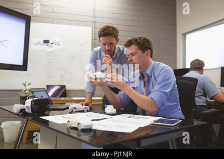 Business colleagues discussing over car model Stock Photo