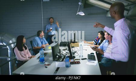 Business people interacting with each other Stock Photo