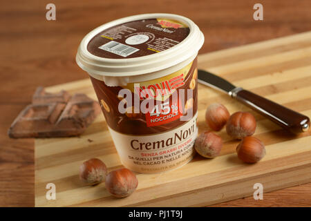 Hazelnut chocolate cream, authentic Italian specialty in a container. High quality of hazelnuts. Spreadable. Closeup Stock Photo