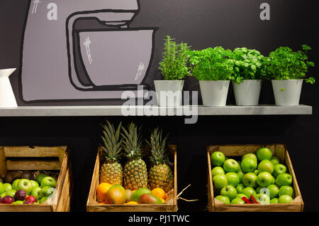 fresh fruits and spices on shelf with illustration on dark wall Stock Photo