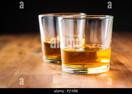 Glass of alcoholic drink wooden table. Whiskey in glass. Stock Photo