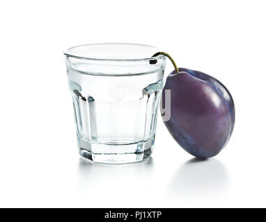 Plum brandy and plums. Tasty slivovitz isolated on white background. Stock Photo