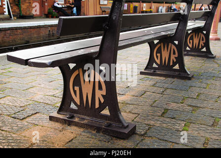 Close up view of a restored bench on Bewdley railway station. In the metal frame are the initials of GWR representing the Great Western Railway Stock Photo