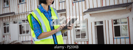 Composite image of female architect using digital tablet Stock Photo