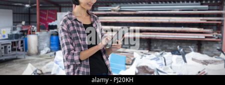 Composite image of female architect using digital tablet against white background Stock Photo