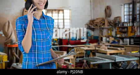 Composite image of female architect talking on mobile phone Stock Photo