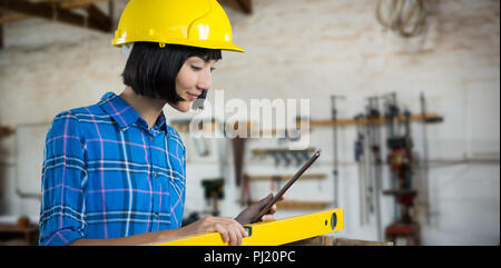 Composite image of female architect measuring plywood with engineer scale Stock Photo