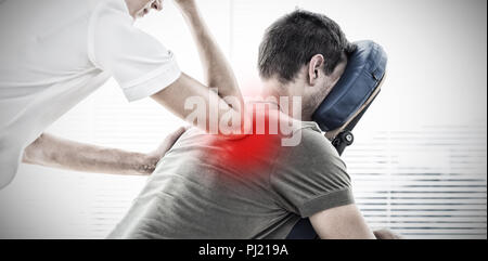 Composite image of therapist giving back massage to man Stock Photo