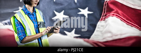 Composite image of female architect using digital tablet Stock Photo