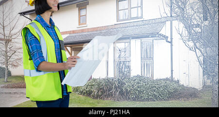 Composite image of female architect looking at blueprint against grey background Stock Photo