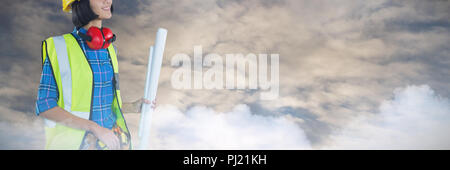 Composite image of female architect holding blueprint against grey background Stock Photo