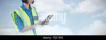 Composite image of female architect using digital tablet Stock Photo