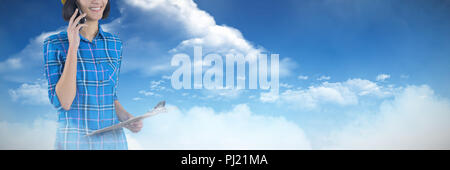 Composite image of female architect talking on mobile phone Stock Photo