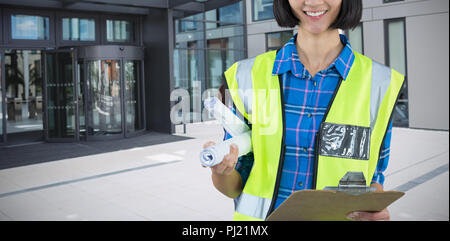 Composite image of female architect holding clipboard and blueprint against grey background Stock Photo