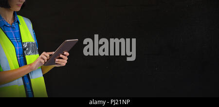 Composite image of female architect using digital tablet Stock Photo