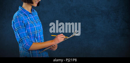 Composite image of female architect writing on clipboard against grey background Stock Photo