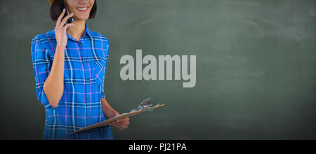 Composite image of female architect talking on mobile phone Stock Photo